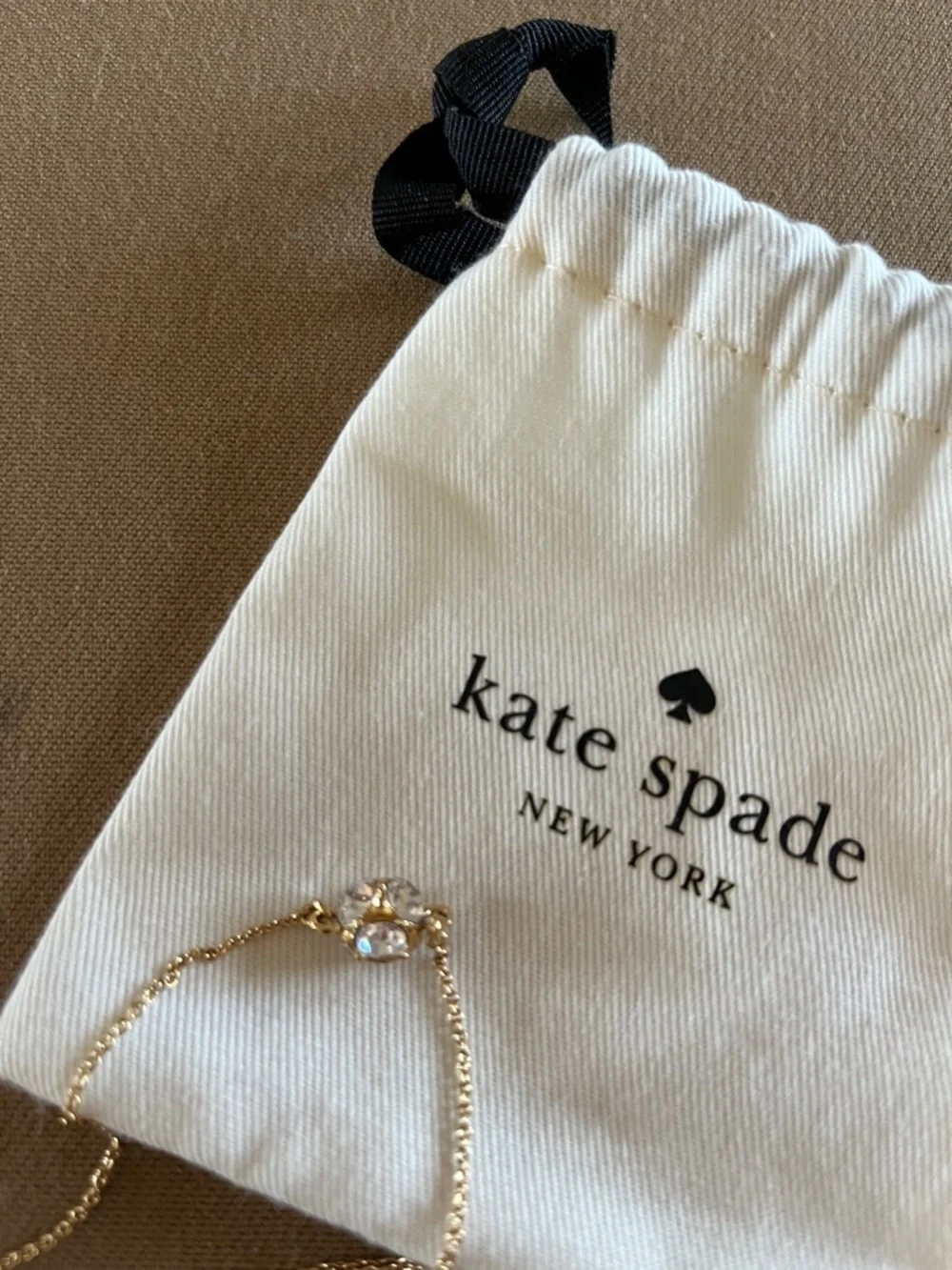 Kate Spade long golden necklace with crystal beads.